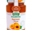 Stute Apricot Jam glass jar with spoon and fresh apricots on wooden table